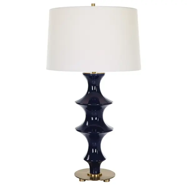 A Contemporary Tribute To Classic Chinoiserie, This Table Lamp's Fluted Base Is Formed From Sculpted Ceramic In A Rich Cobalt Gloss Glaze, Accented By Antique Brass Plated Hardware. The Slightly Tapered Drum Shade Is Covered In A Classic White Linen Fabric. Collection: Coil Designer: Carolyn Kinder Finish: Antique Brass Glass: Round Hardback Shade Width: 15.00" Height: 28.75" Length: 15.00" Weight: 7.00 lb Number of Bulbs: 1 Maximum Wattage: 150.00 W Bulb Type: A Voltage: 110.00 V Material: Ceramic, Iron, Fabric Country of Origin: China Safety Rating: Indoor Only