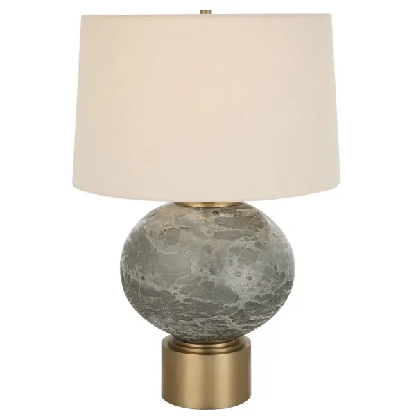 The Lunia Table Lamp Showcases A Beautiful, Smoky Gray Art Glass Center With A Textured Surface, Accented By Antique Brushed Brass Hardware. The Tapered Hardback Shade Is Covered In A Light Oatmeal Linen Fabric With Natural Slubbing. Collection: Lunia Designer: David Frisch Finish: Antique Brushed Brass Glass: Round Hardback Shade Width: 17.00" Height: 25.00" Length: 17.00" Weight: 13.20 lb Number of Bulbs: 1 Maximum Wattage: 150.00 W Bulb Type: A Voltage: 110.00 V Material: Iron & Glass & Linen Country of Origin: China Safety Rating: Indoor Only