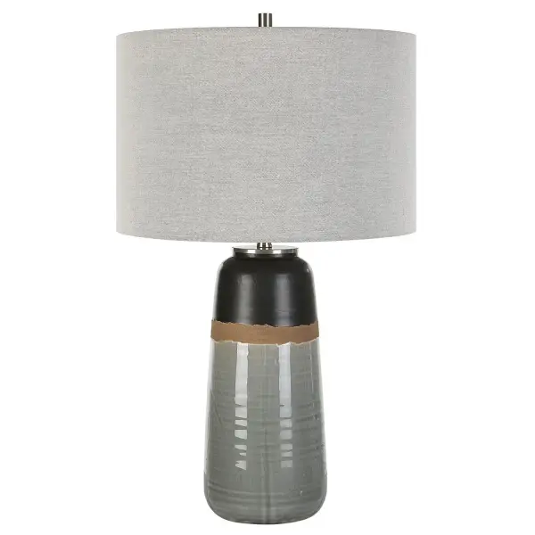 This Ceramic Table Features A Warm Gray And Aged Black Glaze Finish Separated By A Rustic Brown Uneven Band, Accented With Brushed Nickel Details. The Round Drum Shade Is Made With A Casual Light Gray Linen Fabric. Due To The Nature Of Fired Glazes On Ceramic Lamps, Finishes Will Vary Slightly. Collection: Coen Designer: Osvaldo Mendoza Finish: Brushed Nickel Glass: Round Drum Hardback Shade Width: 15.00" Height: 25.50" Length: 15.00" Weight: 6.00 lb Number of Bulbs: 1 Maximum Wattage: 150.00 W Bulb Type: A Voltage: 110.00 V Material: Steel, Ceramic, Fabric Country of Origin: China Safety Rating: Indoor Only