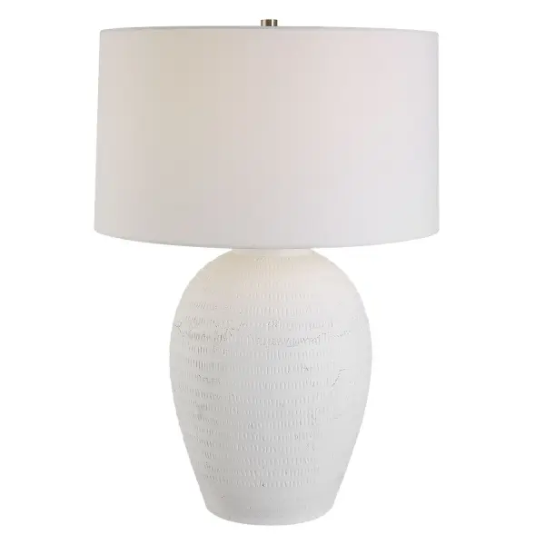 This Ceramic Table Lamp Features A Timeless Urn Shape Finished In A Chalk White Glaze With Updated Hand Carved Texture And Subtle Distressing, Accented With Brushed Nickel Details. The Slightly Tapered Large Round Shade Is Made In A Casual White Linen Fabric. Collection: Reyna Designer: Carolyn Kinder Finish: Brushed Nickel Glass: Round Hardback Shade Width: 20.00" Height: 28.50" Length: 20.00" Weight: 20.00 lb Number of Bulbs: 1 Maximum Wattage: 150.00 W Bulb Type: A Voltage: 110.00 V Material: Steel, Ceramic, Fabric Country of Origin: China Safety Rating: Indoor Only