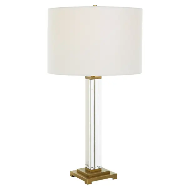 Clean Lines Define This Simplistic Design Featuring An Upscale Square Column Crystal Base Paired With Antique Brass Plated Details. The Square Shapes Of The Base Switch To A Petite Round Neck, Finial And Drum Shade In A Crisp White Linen Fabric. Collection: Crystal Column Finish: Antique Brass Glass: Round Drum Hardback Shade Width: 15.00" Height: 28.00" Length: 15.00" Weight: 7.00 lb Number of Bulbs: 1 Maximum Wattage: 150.00 W Bulb Type: A Voltage: 110.00 V Material: Crystal, Iron, Fabric Country of Origin: China Safety Rating: Indoor Only