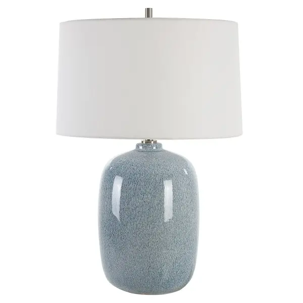 This Ceramic Table Lamp Features A Peaceful Sky Blue Glaze With Cobalt Mottled Details Paired With Plated Brushed Nickel Accents. The Round Hardback Shade Is Covered In A Crisp White Linen Fabric. Due To The Nature Of Fired Glazes On Ceramic Lamps, Finishes Will Vary Slightly. Collection: Jubilee Designer: Osvaldo Mendoza Finish: Brushed Nickel Glass: Round Hardback Shade Width: 18.00" Height: 26.75" Length: 18.00" Weight: 11.00 lb Number of Bulbs: 1 Maximum Wattage: 150.00 W Bulb Type: A Voltage: 110.00 V Material: Steel, Ceramic, Fabric Country of Origin: China Safety Rating: Indoor Only