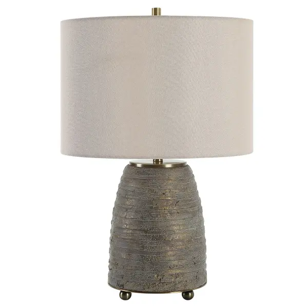 Rustic Meets Sophisticated With The Gorda Lamp. Featuring Heavily Textured Bronze Ceramic With A Green Patina Overlay Accented With Plated Brushed Antiqued Brass Details. The Round Drum Hardback Shade Is A Beige Linen Fabric. Due To The Nature Of Fired Glazes On Ceramic Lamps, Finishes Will Vary Slightly. Collection: Gorda Designer: Osvaldo Mendoza Finish: Antiqued Brass Glass: Round Drum Hardback Shade Width: 15.00" Height: 22.50" Length: 15.00" Weight: 10.00 lb Number of Bulbs: 1 Maximum Wattage: 150.00 W Bulb Type: A Voltage: 110.00 V Material: Steel, Ceramic, Fabric Country of Origin: China Safety Rating: Indoor Only