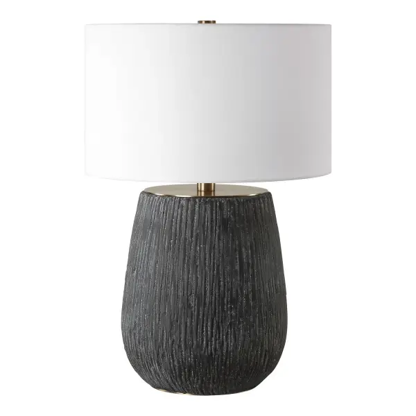This Table Lamp Features A Concrete Base With Deep Organic Texturing Finished In An Aged Black With Light Gray Antiquing, Accented With Brass Plated Details. The Round Hardback Drum Shade Is A Casual White Linen Fabric. Collection: Americana Designer: Matthew Williams Finish: Aged Black Glass: Round Hardback Shade Width: 20.00" Height: 29.00" Length: 20.00" Weight: 24.00 lb Number of Bulbs: 1 Maximum Wattage: 150.00 W Bulb Type: A Voltage: 110.00 V Material: Metal & Concrete Country of Origin: China Safety Rating: Indoor Only