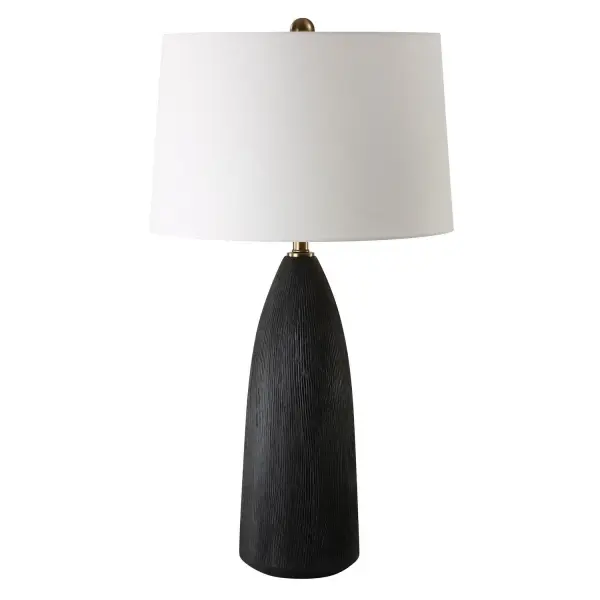 The Jett Table Lamp Showcases A Matte Black Ceramic Base With Organic Texturing, Accented With Plated Antique Brass Details. The Tapered Round Shade Is A Casual White Linen Fabric. Collection: Jett Designer: Carolyn Kinder Finish: Antique Brass Glass: Round Hardback Shade Width: 19.00" Height: 35.00" Length: 19.00" Weight: 10.00 lb Number of Bulbs: 1 Maximum Wattage: 150.00 W Bulb Type: A Voltage: 110.00 V Material: Iron, Ceramic, Linen Country of Origin: China Safety Rating: Indoor Only