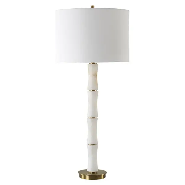 Crafted From Polished Alabaster Meticulously Sculpted Into The Graceful Form Of A Bamboo Shoot, This Table Lamp Exudes Sophistication And Tranquility. Paired With Plated Brass Accents, It Seamlessly Blends Organic Charm With Luxurious Refinement. The Round Hardback Drum Shade Is A Crisp White Linen Fabric. Collection: Unify Designer: Carolyn Kinder Finish: Brass Glass: Round Drum Hardback Shade Width: 14.00" Height: 32.25" Length: 14.00" Weight: 8.00 lb Number of Bulbs: 1 Maximum Wattage: 100.00 W Bulb Type: A Voltage: 110.00 V Material: Alabaster, Iron, Fabric Country of Origin: China Safety Rating: Indoor Only