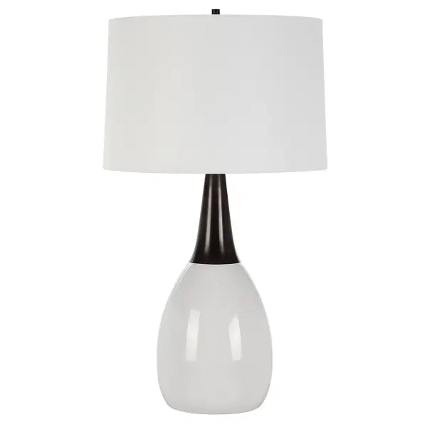 This Unique Table Lamp Seamlessly Blends Elegance And Uniqueness Into One Captivating Design. The Crackled White Ceramic Base Flows Gracefully Into A Black Iron Fluted Neck, Creating A Striking And Seamless Transition. The Lamp Is Topped With A Slightly Tapered Round Hardback Shade In A Crisp White Linen Fabric. Collection: Fralin Designer: Carolyn Kinder Finish: Black Iron Glass: Round Hardback Shade Width: 17.00" Height: 30.50" Length: 17.00" Weight: 12.00 lb Number of Bulbs: 1 Maximum Wattage: 150.00 W Bulb Type: A Voltage: 110.00 V Material: Ceramic, Iron, Fabric Country of Origin: China Safety Rating: Indoor Only