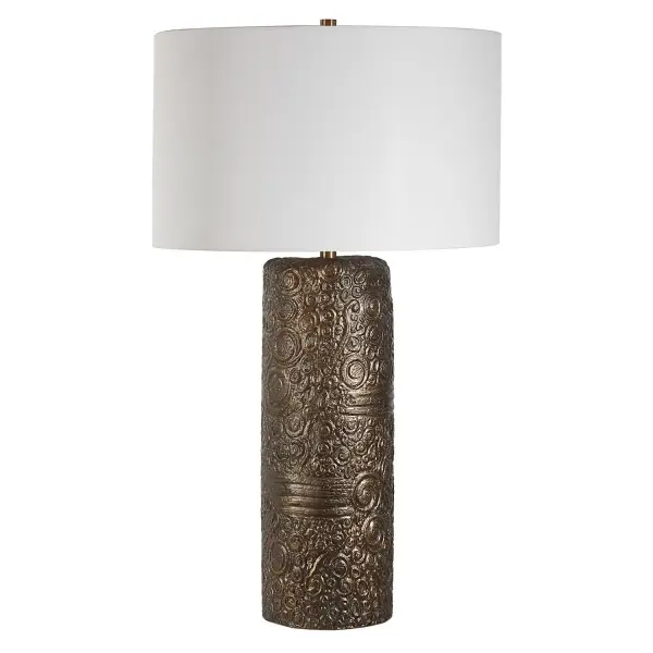 Transform Your Space With The Charm Of Nostalgia Embodied In Our Ceramic Table Lamp. Its Whimsical Carvings And Asymmetrical Column Shape Evoke The Essence Of A Cherished Found Object. Finished In A Distressed Aged Bronze And Accented With Plated Brass Details, It Exudes Timeless Elegance With A Touch Of Vintage Allure. The Round Hardback Drum Shade Is A Crisp White Linen Fabric. Collection: Malaga Designer: Carolyn Kinder Finish: Aged Bronze Glass: Round Drum Hardback Shade Width: 20.00" Height: 35.50" Length: 20.00" Weight: 16.00 lb Number of Bulbs: 1 Maximum Wattage: 150.00 W Bulb Type: A Voltage: 110.00 V Material: Ceramic, Iron, Fabric Country of Origin: China Safety Rating: Indoor Only