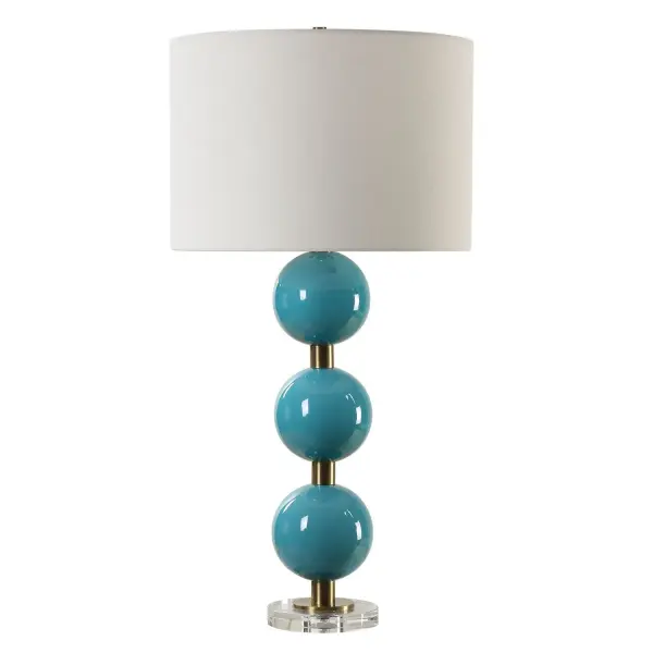 Elevate Your Space With Our Captivating Table Lamp Featuring Stacked Ceramic Spheres Adorned In A Crackled Turquoise Blue Glaze. Enhanced With Plated Antique Brass Details And A Thick Crystal Foot, It Exudes Timeless Elegance And Artistic Charm. The Round Hardback Drum Shade Is A Crisp White Linen Fabric. Collection: Palawan Designer: Carolyn Kinder Finish: Antique Brass Glass: Round Drum Hardback Shade Width: 17.00" Height: 31.25" Length: 17.00" Weight: 10.00 lb Number of Bulbs: 1 Maximum Wattage: 150.00 W Bulb Type: A Voltage: 110.00 V Material: Iron, Ceramic, Crystal, Fabric Country of Origin: China Safety Rating: Indoor Only
