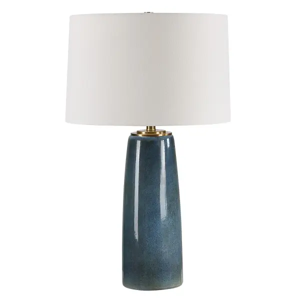 This Ceramic Table Lamp Showcases A Deep Blue Glaze With Rustic Undertones, Accented With Plated Antique Brass Details. The Slightly Tapered Round Hardback Shade Is A Casual White Linen Fabric. Due To The Nature Of Fired Glazes On Ceramic Lamps, Finishes Will Vary Slightly. Collection: Submerged Designer: Carolyn Kinder Finish: Antique Brass Glass: Round Hardback Shade Width: 16.00" Height: 26.25" Length: 16.00" Weight: 7.00 lb Number of Bulbs: 1 Maximum Wattage: 150.00 W Bulb Type: A Voltage: 110.00 V Material: Iron, Ceramic, Fabric Country of Origin: China Safety Rating: Indoor Only