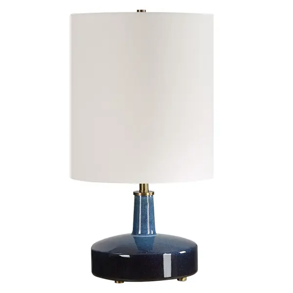 Add A Touch Of Artistic Flair To Your Space With Our Unique Ceramic Table Lamp, Boasting A Captivating Ombre Effect From Light Blue To Midnight Blue. The Granulated Finish Adds Depth, While Brass-plated Details Provide A Hint Of Elegance. The Tall Round Drum Shade Is Covered In A Casual White Linen Fabric. Due To The Nature Of Fired Glazes On Ceramic Lamps, Finishes Will Vary Slightly. Collection: Abyss Designer: Carolyn Kinder Finish: While Brass Glass: Round Drum Hardback Shade Width: 12.00" Height: 22.50" Length: 12.00" Weight: 6.00 lb Number of Bulbs: 1 Maximum Wattage: 150.00 W Bulb Type: A Voltage: 110.00 V Material: Iron, Ceramic, Fabric Country of Origin: China Safety Rating: Indoor Only