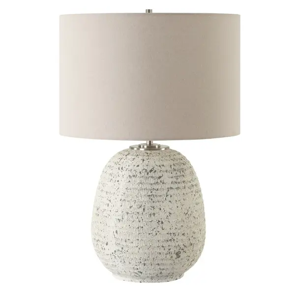 This Ceramic Table Lamp Boast A Ribbed Textured Surface Finished In A Heavily Distressed Stone Ivory With Dark Gray Undertones. Accentuated By Brushed Nickel Plated Details, This Lamp Exudes Rustic Elegance And Charm. The Round Hardback Drum Shade Is A Casual Light Beige Linen Fabric With Natural Slubbing. Collection: Danala Designer: Osvaldo Mendoza Finish: Brushed Nickel Glass: Round Drum Hardback Shade Width: 17.00" Height: 25.25" Length: 17.00" Weight: 13.00 lb Number of Bulbs: 1 Maximum Wattage: 150.00 W Bulb Type: A Voltage: 110.00 V Material: Steel, Ceramic, Fabric Country of Origin: China Safety Rating: Indoor Only