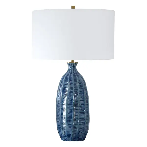 Where Coastal Charm Meets Refined Elegance, Featuring A Heavily Textured Ceramic Base In A Rich Blue Glaze And Enhanced With Plated Antique Brass Finishes. The Round Hardback Shade Is Covered In A White Linen Fabric. Due To The Nature Of Fired Glazes On Ceramic Lamps, Finishes Will Vary Slightly. Collection: Bixby Designer: Grace Feyock Finish: Antique Brass Glass: Drum With Liner Width: 17.00" Height: 28.50" Length: 17.00" Weight: 9.00 lb Number of Bulbs: 1 Maximum Wattage: 150.00 W Bulb Type: A Voltage: 110.00 V Material: Ceramic, Fabric, Metal Country of Origin: Vietnam Safety Rating: Indoor Only