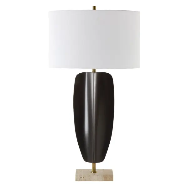 The Kure Table Lamp Is Crafted From Hand Forged Iron Finished In Matte Black, Replicating A Tribal Sculpture That's Suspended By Plated Brass Columns And Displayed On A Thick Travertine Foot. The Oval Hardback Shade Is Covered In A White Linen Fabric. Collection: Kure Designer: John Kowalski Finish: Brass Glass: Oval Hardback Shade Width: 16.00" Height: 30.25" Length: 10.00" Weight: 6.40 lb Number of Bulbs: 1 Maximum Wattage: 150.00 W Bulb Type: A Voltage: 110.00 V Material: Iron, Travertine, Fabric Country of Origin: China Safety Rating: Indoor Only