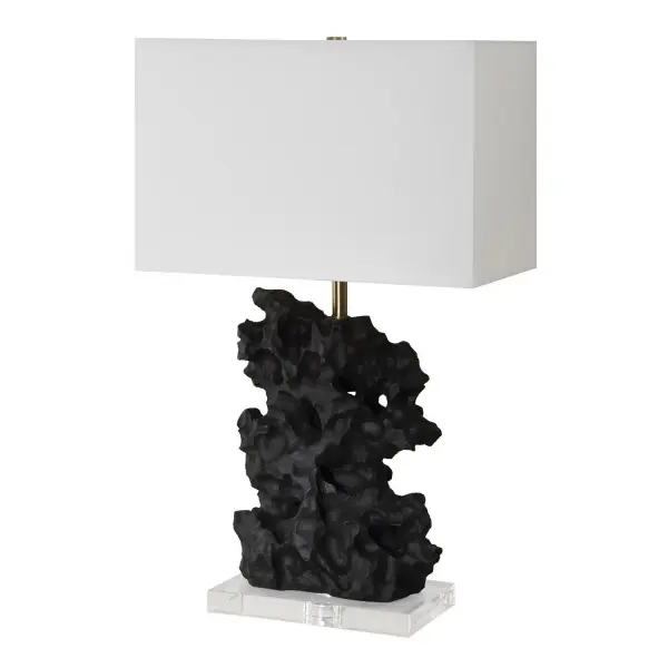 Crafted From A Black Man-made Stone, This Unique Table Lamp Replicates A Rock Sculpture That Boasts Heavy Texture With Distinctive Holes, Displayed Atop A Thick Crystal Base With Plated Antique Brass Hardware. The Rectangle Drum Shade Is Covered In A Crisp White Linen Fabric. Collection: Basalt Designer: Carolyn Kinder Finish: Antique Brass Glass: Rectangle Drum Shade Width: 17.00" Height: 27.25" Length: 10.00" Weight: 24.00 lb Number of Bulbs: 1 Maximum Wattage: 150.00 W Bulb Type: A Voltage: 110.00 V Material: Steel, Crystal, Fabric, Faux Resin Country of Origin: Cambodia Safety Rating: Indoor Only