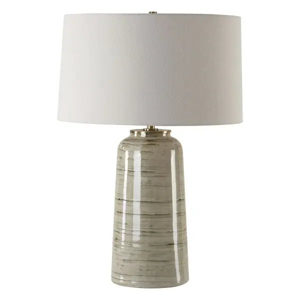 This Ceramic Table Lamp Features A Greenish Tan Glaze With Dark Undertones, Accented With Plated Antique Brass Details. The Slightly Tapered Round Hardback Shade Is Covered In A White Linen Fabric With Slubbing. Due To The Nature Of Fired Glazes On Ceramic Lamps, Finishes Will Vary Slightly. Collection: Strata Designer: Osvaldo Mendoza Finish: Antique Brass Glass: Round Hardback Shade Width: 18.00" Height: 26.25" Length: 18.00" Weight: 9.00 lb Number of Bulbs: 1 Maximum Wattage: 150.00 W Bulb Type: A Voltage: 110.00 V Material: Steel, Ceramic, Fabric Country of Origin: China Safety Rating: Indoor Only