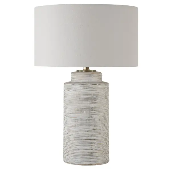This Ceramic Table Lamp Features Heavy Ribbed Texture Finished In A Heavily Distressed Ivory Glaze With Gold Leaf Undertones, Accented With Plated Brass Details. A Round Hardback Drum Shade Finished In A Casual White Linen Fabric Completes The Piece. Collection: Crimp Designer: Carolyn Kinder Finish: Brass Glass: Round Hardback Shade Width: 18.00" Height: 26.50" Length: 18.00" Weight: 11.00 lb Number of Bulbs: 1 Maximum Wattage: 150.00 W Bulb Type: A Voltage: 110.00 V Material: Steel, Ceramic, Fabric Country of Origin: China Safety Rating: Indoor Only