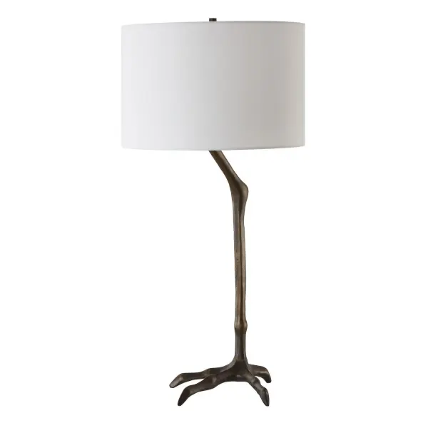 This Unique Table Lamp Combines Nature-inspired Elegance With A Touch Of Whimsy, Featuring A Slender, Cast Iron Bird-leg Silhouette That Adds An Artistic Flair To Any Room And Finished In A Plated Warm Antique Bronze. The Round Hardback Drum Shade Is Made In A Casual White Linen Fabric. Collection: Perch Designer: Osvaldo Mendoza Finish: Antique Bronze Glass: Round Drum Hardback Shade Width: 15.00" Height: 31.00" Length: 15.00" Weight: 8.00 lb Number of Bulbs: 1 Maximum Wattage: 150.00 W Bulb Type: A Voltage: 110.00 V Material: Ceramic, Casting Iron, Fabric Country of Origin: China Safety Rating: Indoor Only