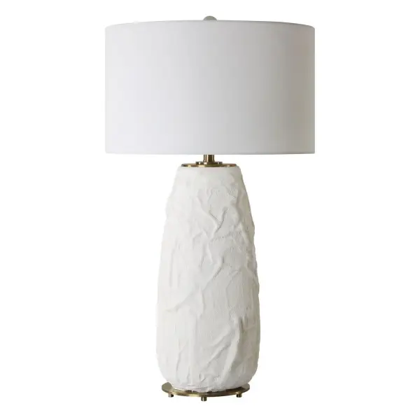 The Vida Table Lamp Base Features A Ceramic Base With A Uniquely Textured Surface And Soft, Flowing Lines. Finished In A Chalk White Glaze And Accented With Plated Brushed Brass Accents And Matching Textured Finial. The Large Round Drum Hardback Shade Is Made In A Casual White Linen Fabric. Collection: Vida Designer: Carolyn Kinder Finish: Brushed Brass Glass: Round Drum Hardback Shade Width: 19.00" Height: 33.00" Length: 19.00" Weight: 15.00 lb Number of Bulbs: 1 Maximum Wattage: 150.00 W Bulb Type: A Voltage: 110.00 V Material: Steel, Ceramic, Fabric Country of Origin: China Safety Rating: Indoor Only