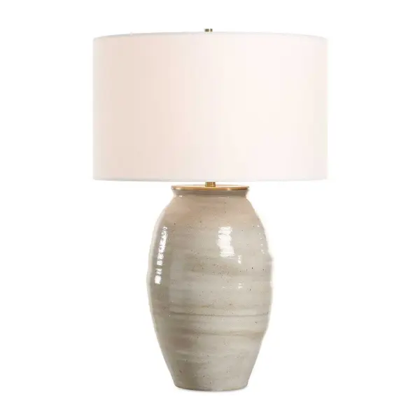 This Ceramic Table Lamp Features A Rustic Light Gray Glaze Paired With Heavily Antique Gold Accents. The Round Hardback Shade Is Covered In A Timeless White Linen Fabric. Due To The Nature Of Fired Glazes On Ceramic Lamps, Finishes Will Vary Slightly. Collection: Amos Designer: Jim Parsons Finish: Antique Gold Glass: Drum Hardback Rolled Edge Width: 17.00" Height: 25.75" Length: 17.00" Weight: 13.20 lb Number of Bulbs: 1 Maximum Wattage: 150.00 W Bulb Type: A Voltage: 110.00 V Material: Steel & Ceramic, Fabric Country of Origin: China Safety Rating: Indoor Only