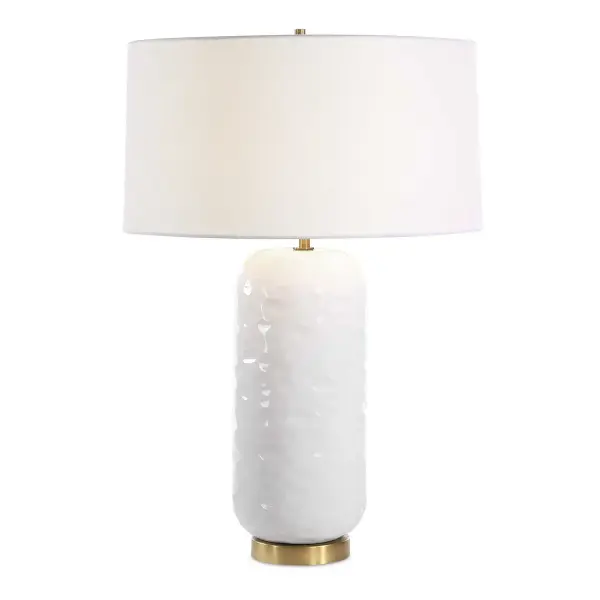 Effortlessly Chic And Versatile, The Iona Table Lamp Features A White Glaze On A Slightly Textured Ceramic Base, Complemented By Refined Brushed Brass Plated Details. This Lamp Is Paired With A Slightly Tapered White Linen Fabric Drum Shade. Collection: Iona Designer: Matthew Williams Finish: Brushed Brass Glass: Round Hardback Shade Width: 20.00" Height: 29.00" Length: 20.00" Weight: 9.37 lb Number of Bulbs: 1 Maximum Wattage: 150.00 W Bulb Type: C Light Source: CFL Voltage: 110.00 V Material: Ceramic, Metal , Fabric Country of Origin: China Safety Rating: Indoor Only
