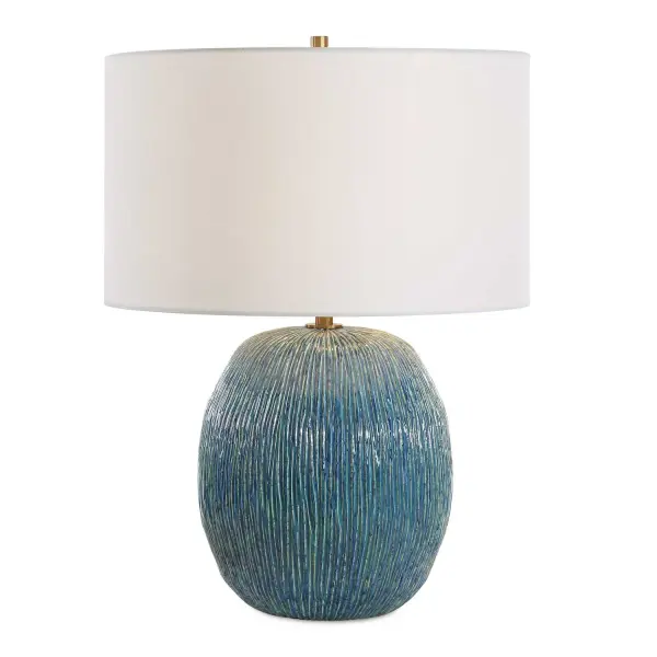 This Ceramic Table Lamp Features An Interesting Organic Texture Of Vertical Cuts. The Reactive Glaze Naturally Creates A Dynamic Layering Of Different Levels Of Beautiful Blues, Greens, And Creams, Paired With Antique Brass Plated Details. A Round Hardback Drum Shade Made With A Casual White Linen Fabric Completes The Piece. Due To The Nature Of Fired Glazes On Ceramic Lamps, Finishes Will Vary Slightly. Collection: Elysia Designer: Renee Wightman Finish: Antique Brass Glass: Round Drum Hardback Width: 17.00" Height: 23.25" Length: 17.00" Weight: 9.50 lb Number of Bulbs: 1 Maximum Wattage: 150.00 W Bulb Type: A Voltage: 110.00 V Material: Ceramic , Iron, Fabric Country of Origin: China Safety Rating: Indoor Only