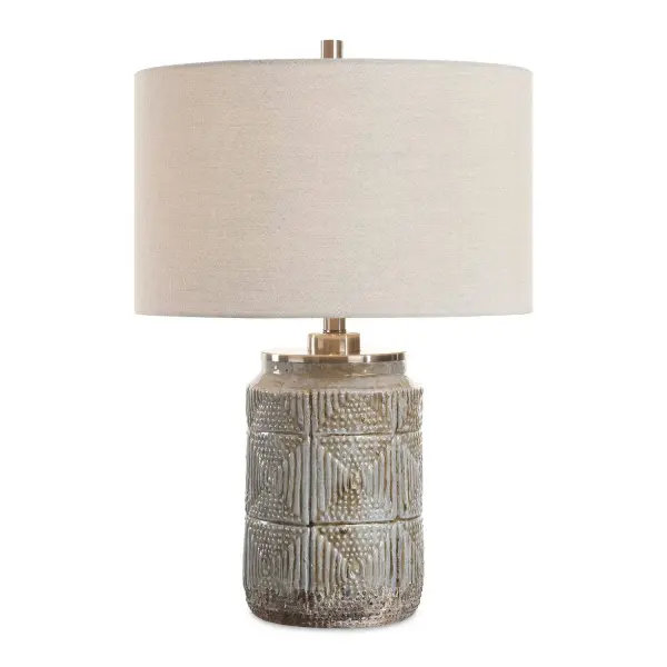 The Graydon Table Lamp Features A Dusty Gray Ceramic Base Adorned With Intricate Etchings That Evoke A Tribal Aesthetic And Paired With Plated Brushed Nickel Accents. The Round Hardback Drum Shade Is A Warm Gray Linen Fabric With Light Slubbing. Collection: Graydon Designer: Carolyn Kinder Finish: Brushed Nickel Glass: Round Drum Hardback Shade Width: 17.00" Height: 24.50" Length: 17.00" Weight: 14.00 lb Number of Bulbs: 1 Maximum Wattage: 150.00 W Bulb Type: A Voltage: 110.00 V Material: Steel, Ceramic, Fabric Country of Origin: China Safety Rating: Indoor Only