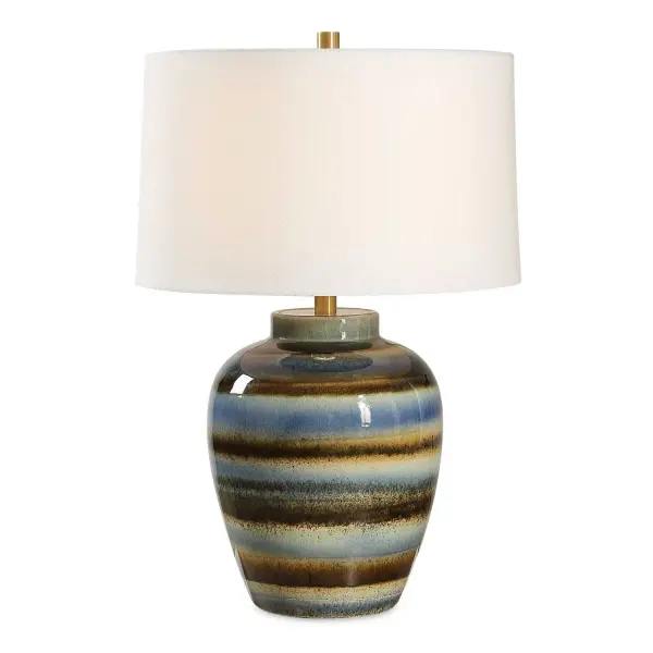 The Judarn Table Lamp Features A Distinctive Artisan-crafted Aesthetic, Blending Earthy Shades Of Blue, And Rust Brown Glazes Over A Timeless Urn Shape Ceramic Base, Accented With Plated Antique Brass Details. The Slightly Tapered Hardback Shade Is Covered In A White Linen Fabric. Due To The Nature Of Fired Glazes On Ceramic Lamps, Finishes Will Vary Slightly. Collection: Judarn Designer: Carolyn Kinder Finish: Antique Brass Glass: Round Hardback Shade Width: 17.00" Height: 25.50" Length: 17.00" Weight: 10.00 lb Number of Bulbs: 1 Maximum Wattage: 150.00 W Bulb Type: A Voltage: 110.00 V Material: Ceramic, Iron, Fabric Country of Origin: China Safety Rating: Indoor Only