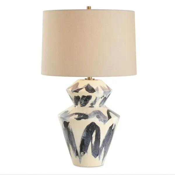 This Striking Table Lamp Is Designed To Capture Attention With Its Geometric, Faceted Ceramic Base, Complemented By An Eye-catching Abstract Pattern In Rich Blue And Cream Tones, Paired With Antique Brass Plated Accents. The Slightly Tapered Round Hardback Shade Is Covered In An Off-white Linen Fabric. Due To The Nature Of Fired Glazes On Ceramic Lamps, Finishes Will Vary Slightly. Collection: Oranda Designer: Matthew Williams Finish: Antique Brass Plated Glass: Tapered Round Hardback Shade Width: 17.00" Height: 28.50" Length: 17.00" Weight: 9.50 lb Number of Bulbs: 1 Maximum Wattage: 150.00 W Bulb Type: A Voltage: 110.00 V Material: Ceramic, Metal , Fabric Country of Origin: China Safety Rating: Indoor Only