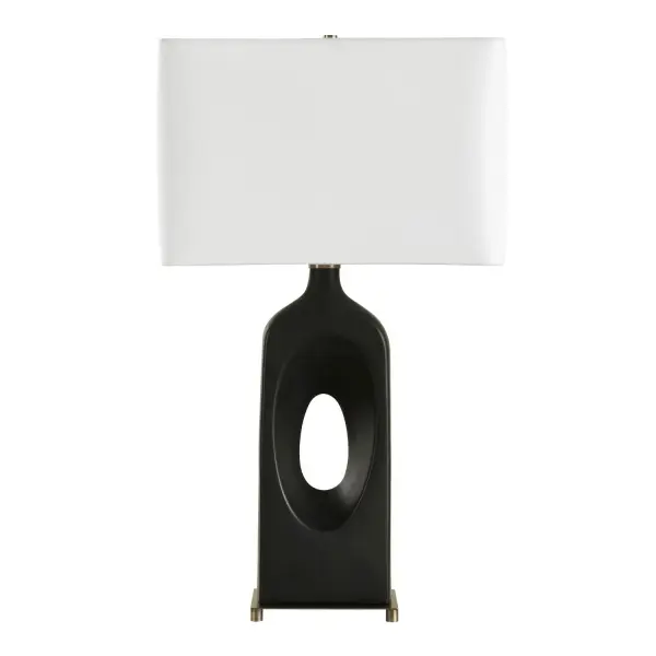 The Void Table Lamp Showcases A Bold, Geometric Ceramic Base Finished In A Matte Black Glaze, Accented By Brass Plated Detailing. The Rectangular Hardback Shade Is Covered In A Crisp White Linen Fabric. Collection: Void Designer: David Frisch Finish: Brass Width: 17.00" Height: 30.00" Length: 10.00" Weight: 10.00 lb Number of Bulbs: 1 Maximum Wattage: 150.00 W Bulb Type: A Voltage: 110.00 V Material: Metal, Ceramic, Fabric Country of Origin: Cambodia Safety Rating: Indoor Only