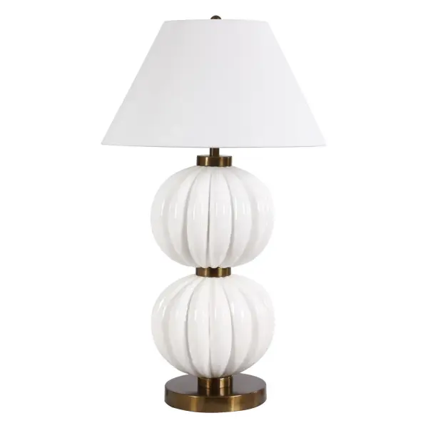 The Irena Table Lamp Features Stacked Ribbed Spheres Finished In A Glossy White Glaze, Accented With Heavily Antiqued Brass Plated Details. The Tapered Round Hardback Shade Is Covered In A Crisp White Linen. Collection: Irena Designer: Matthew Williams Finish: Antique Brass Width: 22.00" Height: 38.50" Length: 22.00" Weight: 24.00 lb Number of Bulbs: 1 Maximum Wattage: 150.00 W Bulb Type: A Voltage: 110.00 V Material: Ceramic ,Iron , Shade Country of Origin: China Safety Rating: Indoor Only