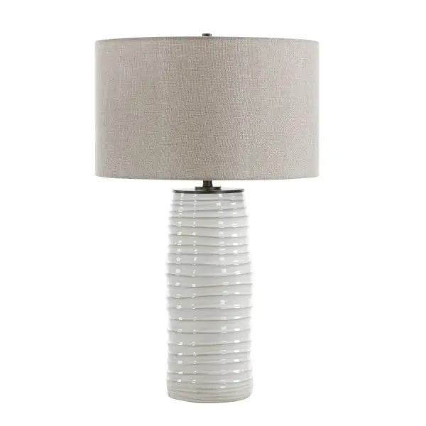 Infusing Warmth And Tactile Interest, This Table Lamp Features A Distressed Warm White Ceramic Base With Dark Undertones, Intricately Textured With Irregular Ridges. Its Design Is Elevated By Sleek Black Accents. The Round Hardback Drum Shade Is Covered In A Dark Beige Linen Fabric. Collection: Barat Designer: Renee Wightman Finish: Sleek Black Width: 17.00" Height: 27.50" Length: 17.00" Weight: 7.20 lb Number of Bulbs: 1 Maximum Wattage: 150.00 W Bulb Type: A Voltage: 110.00 V Material: Iron,Ceramic,Fabric Country of Origin: China Safety Rating: Indoor Only