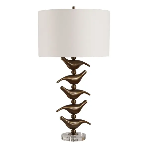 Add A Touch Of Whimsical Elegance With This Charming Table Lamp, Featuring Five Meticulously Crafted Iron Songbirds In A Rich, Antiqued Golden Bronze Finish. The Playfully Stacked Silhouette Is Elevated By A Solid, Clear Crystal Foot. The Round Hardback Drum Shade Is Covered In A Casual White Linen Fabric. Collection: Sing Song Designer: Renee Wightman Finish: Antiqued Gold Width: 16.00" Height: 29.75" Length: 16.00" Weight: 7.48 lb Number of Bulbs: 1 Maximum Wattage: 150.00 W Bulb Type: A Voltage: 110.00 V Material: Iron,Crystal,Fabric Country of Origin: China Safety Rating: Indoor Only