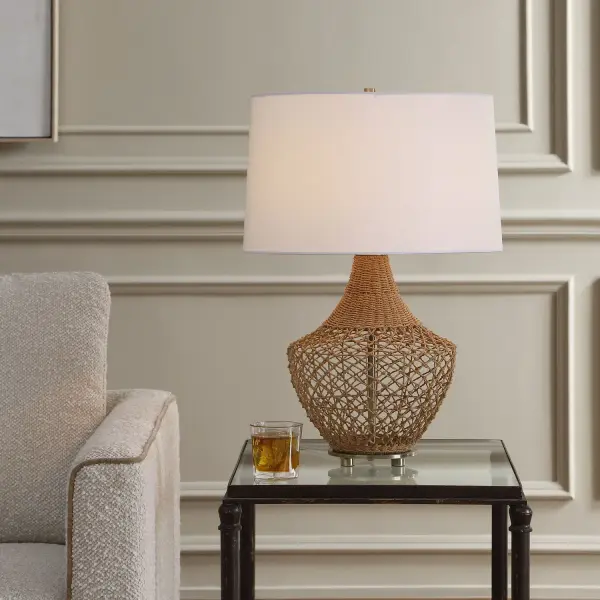 Featuring An Intricate, Hand Woven Rattan Base, Accented By Antique Brass Metal Accents. The Slightly Tapered Round Hardback Drum Shade Is Covered In A Crisp White Linen Fabric. Collection: Samori Finish: Antique Brass Width: 17.00" Height: 24.50" Length: 17.00" Weight: 5.50 lb Number of Bulbs: 1 Maximum Wattage: 150.00 W Bulb Type: A Voltage: 110.00 V Material: Steel,Rattan,Fabric Country of Origin: China Safety Rating: Indoor Only