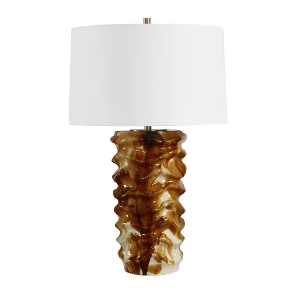 The Bassa Table Lamp Features A Uniquely Rippled Ceramic Base, Showcasing A High-gloss Drip Glaze Where Cream And Caramel Tones Blend Seamlessly Into Deep Brown Accents. The Design Is Elevated By Antique Brass Hardware And Topped With A Slightly Tapered Round Hardback Drum Shade Covered In A Clean, White Linen Fabric. Due To The Nature Of Fired Glazes On Ceramics, Finishes Will Vary Slightly. Collection: Bassa Designer: Carolyn Kinder Finish: Antique Brass Width: 17.00" Height: 27.25" Length: 17.00" Weight: 9.90 lb Number of Bulbs: 1 Maximum Wattage: 150.00 W Bulb Type: A Voltage: 110.00 V Material: CERAMIC,IRON,FABRIC Country of Origin: China Safety Rating: Indoor Only