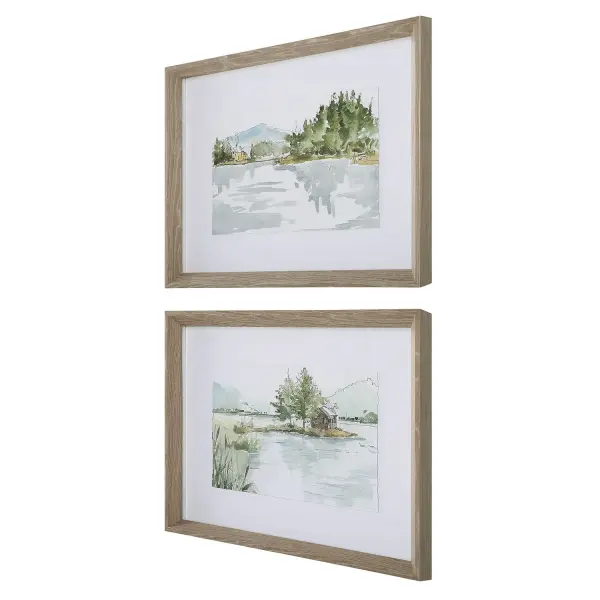 A calming pair of framed lake-view sketches with soft blue, green, and mustard tones, set in gray washed pine frames for a relaxed coastal-farmhouse look.