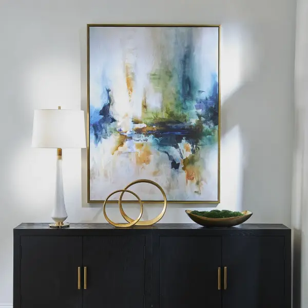 A giclee canvas print with a solid wood gold-finished frame, blending blue, teal, yellow, and orange tones. Versatile hanging orientation adds flexibility for varied wall spaces.