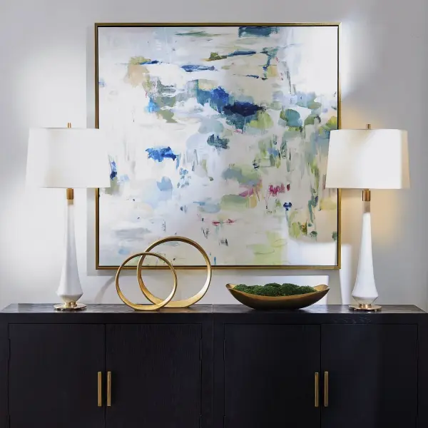 A large handcrafted abstract canvas in green, blue, and fuchsia tones, framed in a solid wood gold gallery frame. Versatile hanging orientation adds flexibility for various wall spaces.