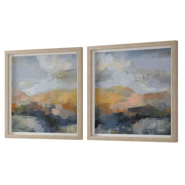 This set of two framed abstract prints brings soft dusty peach and Prussian blue tones to a room, framed in natural wood grain with a white linen liner accent.