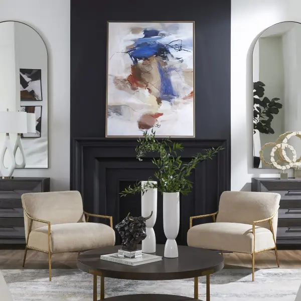 A large-scale abstract canvas blending burnt orange and blue accents on beige, framed in a bronze gold gallery frame. Versatile hanging orientation and handcrafted USA construction.
