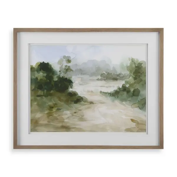 This framed print pairs a lush green watercolor scene with a crisp white double mat and light oak wood frame, adding a calming natural touch to walls.