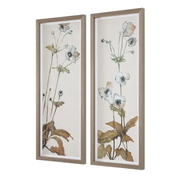 A pair of framed watercolor-style floral prints in light oak frames with crisp white linen mats, offering understated color and texture for traditional or farmhouse interiors.