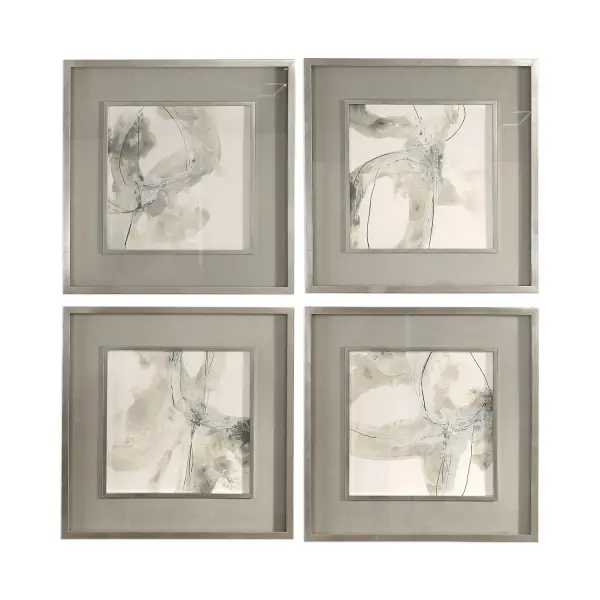 A set of four abstract prints in earthy neutral tones, framed in bright silver leaf with protective glass. Clean and contemporary for a gallery wall.