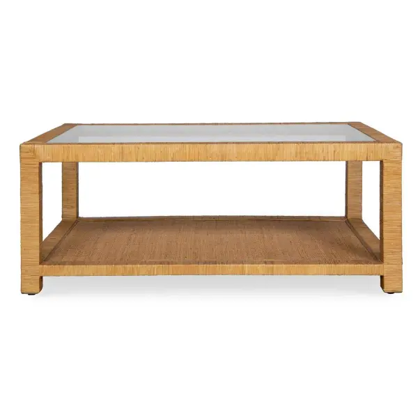 This Casual Coffee Table Offers Generous Display Space And Exudes A Rustic Charm With Its Natural Rattan Wrap Finish, Complemented By A Sleek Glass Top. Collection: Kensing Designer: Osvaldo Mendoza Finish: Natural Rattan Width: 42.00" Height: 17.00" Length: 28.00" Weight: 55.50 lb Material: Mango Wood With Rattan Core Country of Origin: Indonesia Safety Rating: Indoor Only
