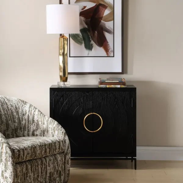 This Cabinet Is Expertly Crafted From Black Fir Wood, Featuring Doors Adorned With A Striking Concentric Circle Carving For Depth And Texture. The Design Is Elegantly Completed By Bold Antique Gold Iron Ring Pulls And Grounded By A Sleek Black Iron Base. Collection: Briseis Finish: Antique Gold Width: 36.00" Height: 34.13" Length: 15.00" Weight: 59.96 lb Material: FIR, MDF, Iron, Red Oak Veneer Country of Origin: China Safety Rating: Indoor Only