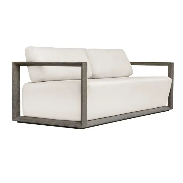 The Remsen Outdoor Sofa Features A Striking Architectural Frame With Smooth Interior Curves That Give A Sculptural Presence. Constructed Of Solid Mahogany Wood In A Weathered Gray Finish With Wire-brushed Details. Its Generously Cushioned Floating Seat, Upholstered In An Oyster White Solution Dyed Acrylic Fabric, Is Designed To Withstand The Moisture And Dirt That Comes With Outdoor Use. Solid Wood Will Continue To Move With Temperature And Humidity Changes, Which Can Result In Cracks And Uneven Surfaces, Adding To Its Authenticity And Character. Collection: Remsen Designer: Matthew Williams Finish: Solid Mahogany Width: 81.00" Height: 32.00" Length: 36.25" Weight: 96.54 lb Material: Mahogany Wood And Fabric Crescent Cloud DancerCloud Dancer Country of Origin: Indonesia Safety Rating: Indoor/Outdoor