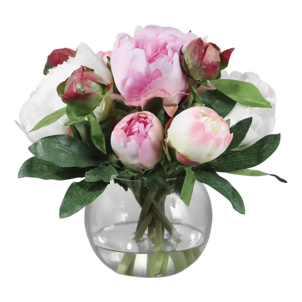 A soft pink-and-cream faux peony arrangement in a clear glass vase with faux water, offering low-maintenance decorative charm for tabletops and shelves.
