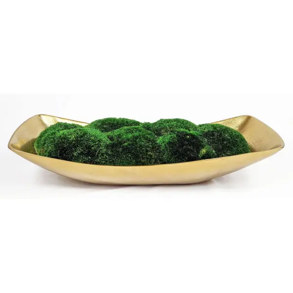 A textured cast aluminum boat centerpiece finished in antique brass, filled with preserved moss for an organic, decorative touch on any tabletop.