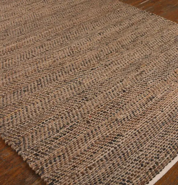 A hand-woven rug crafted from rescued Italian leather and natural hemp, bringing organic texture to living rooms and offices. Best suited for low-traffic areas.