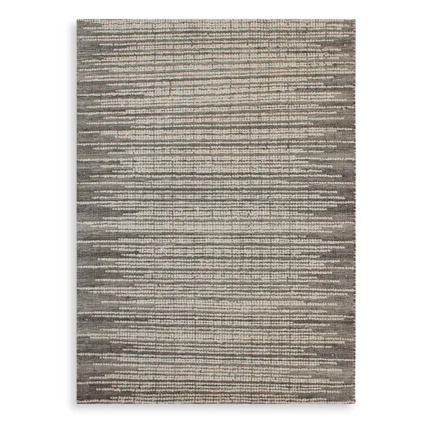An undyed gray wool rug with looped ivory raised detailing, hand woven in India for an organic, textured look that suits relaxed, natural interiors.